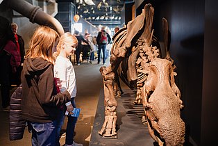 Zwei Kinder vor einem tierischem Skelette der Urzeit.