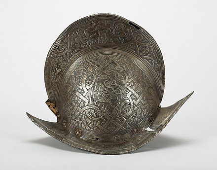 This parade helmet made of brass and iron is better known as a morion. A striking feature is the etched decoration that adorns the entire helmet. 